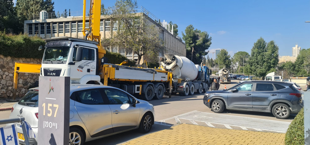 Concrete trucks line the street